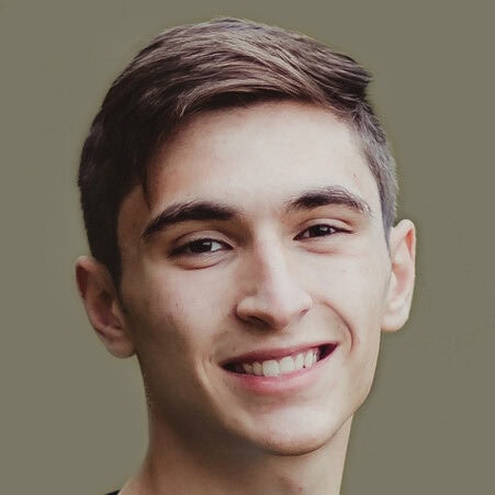 Bright smiling young man at Camp One Step outdoor camp event, joyful youth camp experience in nature.