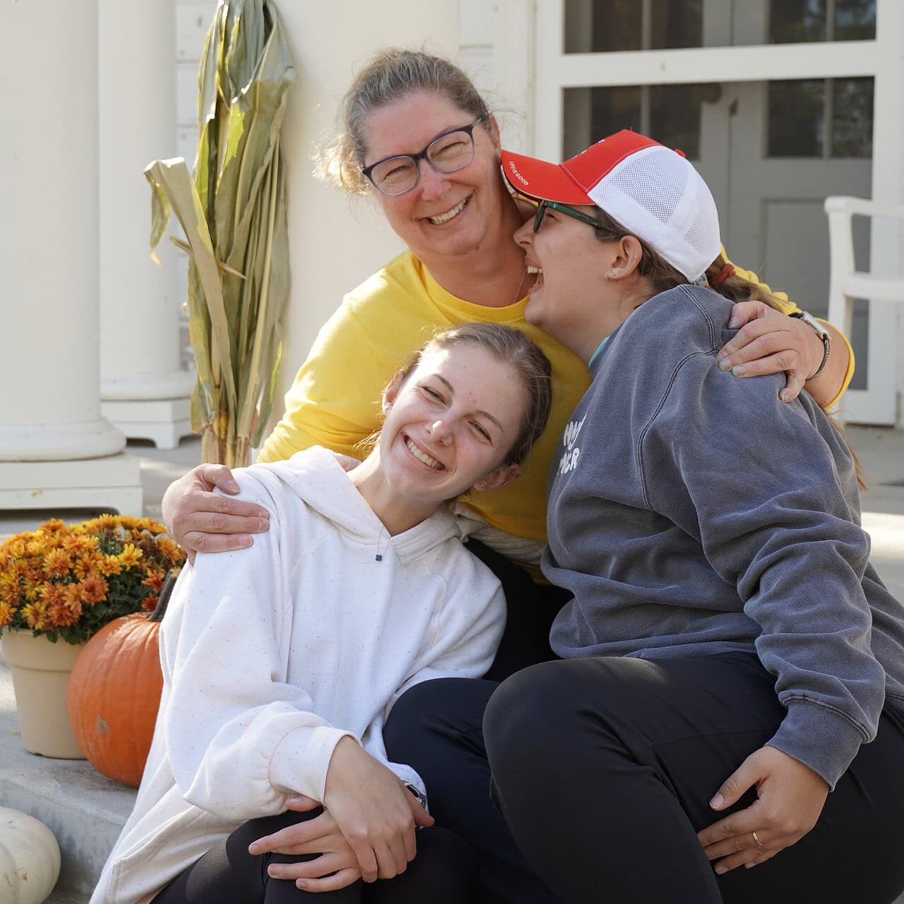 Joyful family hugging outside at Camp One Step event, celebrating community and outdoor fun.