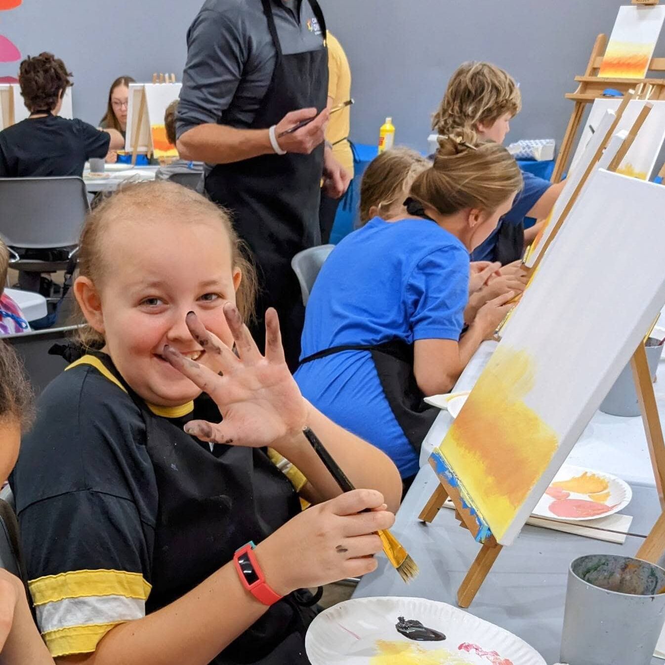 Kids painting art at Camp One Step, summer camp for children with cancer.