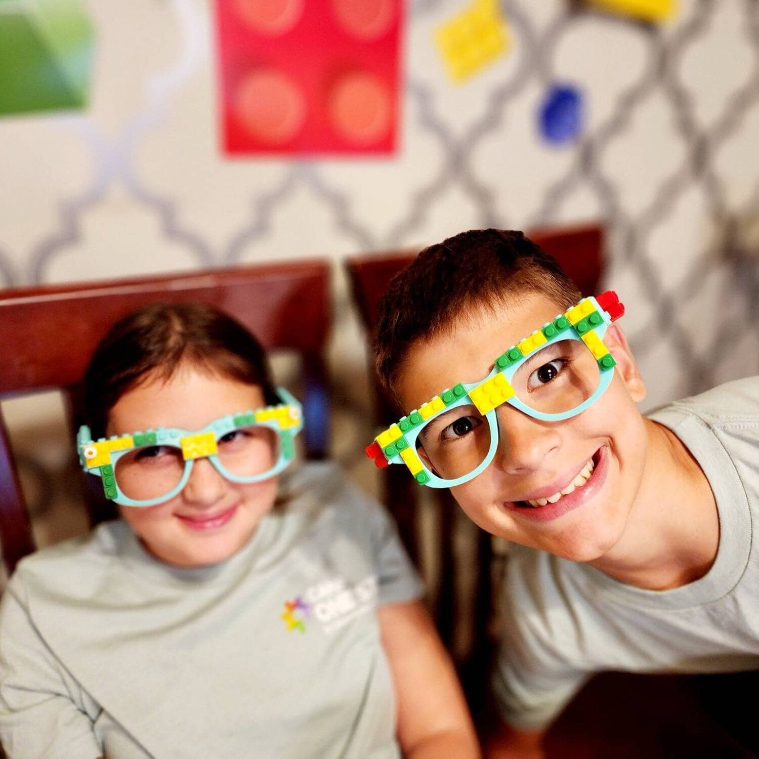 Colorful Lego glasses worn by smiling kids at Camp One Step.
