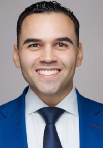 Smiling man in blue suit and tie