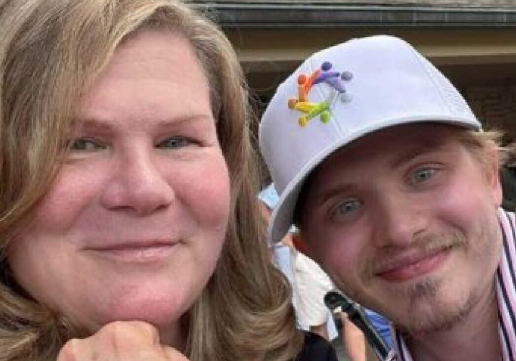Smiling woman and man at Camp One Step outdoor event, sunny day, joyful atmosphere.