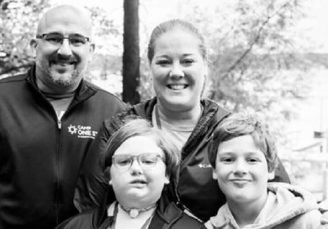 1. Smiling family at Camp One Step outdoor camp for children with cancer.