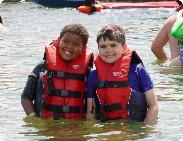 Kids enjoying water activities at Camp One Step waterfront.